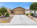 Inviting single-Gathering home featuring desert landscaping, and a spacious two-car garage at 7817 Homing Pigeon St, North Las Vegas, NV 89084