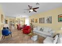 Cozy living room with tile flooring, ceiling fan, and plenty of natural light at 7817 Homing Pigeon St, North Las Vegas, NV 89084