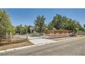Charming single-story home with a gated driveway entrance, lush landscaping at 7898 Wishing Well Rd, Las Vegas, NV 89123