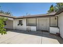 Charming courtyard entrance with stucco walls, decorative accents, and double door entry at 7898 Wishing Well Rd, Las Vegas, NV 89123
