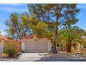 Inviting home with a well-manicured front yard, a two-car garage, and desert landscaping at 8509 Lansdale Rd, Las Vegas, NV 89123