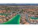 Stunning aerial view overlooking houses on a beautiful lake at 8713 Nautical Bay Ln, Las Vegas, NV 89117