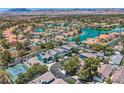 Beautiful aerial view of a lakeside community and houses with pools and tennis courts at 8713 Nautical Bay Ln, Las Vegas, NV 89117