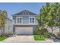 Charming two-story home with a balcony, well-maintained landscaping, and a two-car garage at 8713 Nautical Bay Ln, Las Vegas, NV 89117