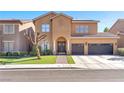 Charming two-story home with a welcoming entrance, manicured lawn, and a spacious driveway leading to the garage at 10654 Sidlaw Hills Ct, Las Vegas, NV 89141