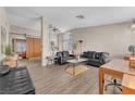 Spacious living room with wood laminate flooring, lots of natural light, and modern decor at 1468 Harmony Hill Dr, Henderson, NV 89014