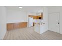 Inviting living space featuring wood-look floors, recessed lighting, and an open flow to the kitchen at 1830 N Buffalo Dr # 2024, Las Vegas, NV 89128