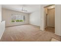 Spacious living room with carpet and natural light through a large window at 2026 Wildwood Lake St, Henderson, NV 89052