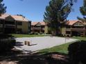 Outdoor recreation area featuring a horseshoe pit surrounded by well-maintained lawns and multi-Gathering residences at 2120 Ramrod Ave # 417, Henderson, NV 89014