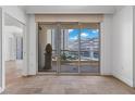 A condo balcony offers city views through a glass sliding door and features tile flooring and a decorative sculpture at 2777 Paradise Rd # 1002, Las Vegas, NV 89109