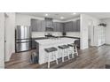 Modern kitchen boasts stainless steel appliances, gray cabinetry, and a center island with seating at 3024 River Brook Ct, Las Vegas, NV 89139
