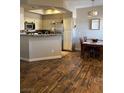 Kitchen, dining nook and rich wood floors create a warm and inviting atmosphere at 3320 S Fort Apache Rd # 139, Las Vegas, NV 89117