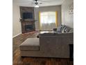 Cozy living room with stone fireplace, ceiling fan and a comfortable sectional at 3320 S Fort Apache Rd # 139, Las Vegas, NV 89117