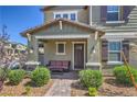 Inviting home exterior featuring a cozy front porch and manicured landscaping at 3778 Via Gennaro, Henderson, NV 89044