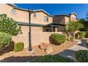 Exterior shot of a desert landscaped backyard with gravel, rocks, stucco wall, pergola, and plants at 5249 Wave Dancer Ln, Las Vegas, NV 89118