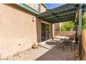 Covered patio with a patio table and chairs, and a sliding glass door at 5249 Wave Dancer Ln, Las Vegas, NV 89118