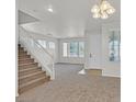 Bright and open living area features a staircase and abundant natural light from multiple windows at 5717 Heineken Dr, North Las Vegas, NV 89031