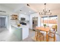 Modern kitchen with stainless appliances, a breakfast bar, and adjacent dining area at 6170 W University Ave, Las Vegas, NV 89103