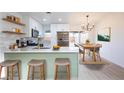 Stylish kitchen with white cabinets, stainless steel appliances, and a breakfast bar at 6170 W University Ave, Las Vegas, NV 89103