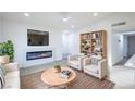 Cozy living room with a modern fireplace, comfortable seating, and a built-in bookcase at 6170 W University Ave, Las Vegas, NV 89103