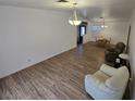 Bright and airy living room featuring modern furnishings and wood-look flooring at 6284 Explorer Dr, Las Vegas, NV 89103