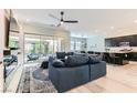 Open-concept living room featuring a large sectional sofa, seamless flow to the kitchen, and bright, airy atmosphere at 704 Webber Park St, Henderson, NV 89011