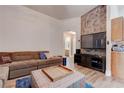 Comfortable living room featuring a large couch, modern decor, and access to other areas of the home at 7120 Bear Paw Creek St # 101, Las Vegas, NV 89149