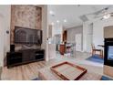 An open concept living area featuring a view of the kitchen, dining area, and fireplace at 7120 Bear Paw Creek St # 101, Las Vegas, NV 89149