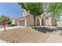 Beautiful home featuring a two-car garage and a landscaped front yard with mature trees providing shade and curb appeal at 7137 Eyebright St, Las Vegas, NV 89131