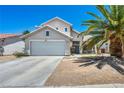 Inviting two-story home featuring a garage, beautiful landscaping, and well-maintained exterior at 818 Grape Vine Ave, Henderson, NV 89002
