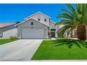 Charming two-story home with a well-manicured lawn, mature landscaping, and inviting curb appeal at 818 Grape Vine Ave, Henderson, NV 89002