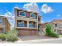 Beautiful two-story home with stone accents, balcony, and three-car garage at 8565 Silver Coast St, Las Vegas, NV 89139