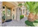 Inviting front door entrance with decorative plants and a brick walkway at 9729 Hawk Crest St, Las Vegas, NV 89141