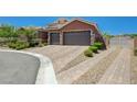 Beautiful brick driveway and mature landscaping leading to the three-car garage at 334 Cougar Estates Ln, Las Vegas, NV 89123