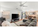 Spacious living room featuring a large sectional couch and a mounted television at 10253 Martinsburg Ct, Las Vegas, NV 89183