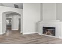 Open living room featuring a cozy fireplace and neutral flooring at 10613 Tiffanieville Ct, Las Vegas, NV 89129