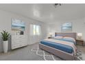 Serene bedroom featuring a plush bed, soft colors, and decorative ocean-themed artwork at 1101 Willow Tree Dr # D, Las Vegas, NV 89128