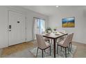 Cozy dining room with seating for six, a stylish table, and bright natural light at 1101 Willow Tree Dr # D, Las Vegas, NV 89128