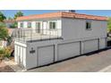 Exterior of a multi-level home with a balcony and multiple garages, offering ample parking at 1101 Willow Tree Dr # D, Las Vegas, NV 89128