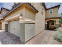 Side view of a charming two-story home with a two-car garage and sidewalk at 1425 Overseer Ave, Henderson, NV 89074