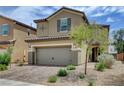 Attractive two-story home with a two-car garage and tidy landscaping under a bright sky at 1425 Overseer Ave, Henderson, NV 89074