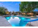 Sparkling pool with a slide and spa, surrounded by landscaped greenery and outdoor lounging areas at 2001 Silver Ave, Las Vegas, NV 89102