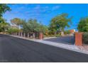 View of the property's gated entrance, showcasing brick pillars and wrought iron fencing at 2001 Silver Ave, Las Vegas, NV 89102