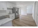 An open concept kitchen with stainless steel appliances and wood-look flooring at 2711 Sesame Dr, Las Vegas, NV 89142