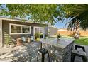 Cozy backyard featuring a custom bar and patio with a seating area, perfect for outdoor entertaining at 3013 Roseville Way, Las Vegas, NV 89102