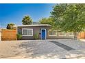 Charming single-story home with a blue front door and manicured desert landscaping at 3013 Roseville Way, Las Vegas, NV 89102