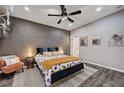 A comfy main bedroom with a ceiling fan, decorative lamps, and a decorative chair at 3013 Roseville Way, Las Vegas, NV 89102