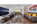 Bright living room with hardwood floors, neutral walls, large windows, and contemporary furnishings at 3200 Mariner Bay St, Las Vegas, NV 89117