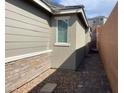 View of the side of a home exterior with brick and stucco at 3447 Sw Covilha Ln, Henderson, NV 89044