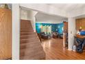 Inviting living room with a staircase, hardwood floors, and a bright color scheme at 3471 One Nation Ave, Las Vegas, NV 89121